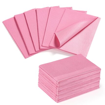 A stack of pink Etercycle disposable nail mats with one unfolded to show its absorbent surface and waterproof backing, ready