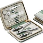 An open MR.GREEN 8-in-1 manicure and pedicure set, showcasing all eight stainless steel tools neatly arranged in a green PU l