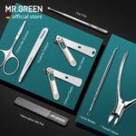 An open MR.GREEN 8-in-1 manicure and pedicure set, showcasing all eight stainless steel tools neatly arranged in a green PU l