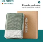 An open MR.GREEN 8-in-1 manicure and pedicure set, showcasing all eight stainless steel tools neatly arranged in a green PU l