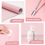 Pink microfiber PU leather nail art table mat rolled up with a strap, next to the mat unrolled showing its texture.